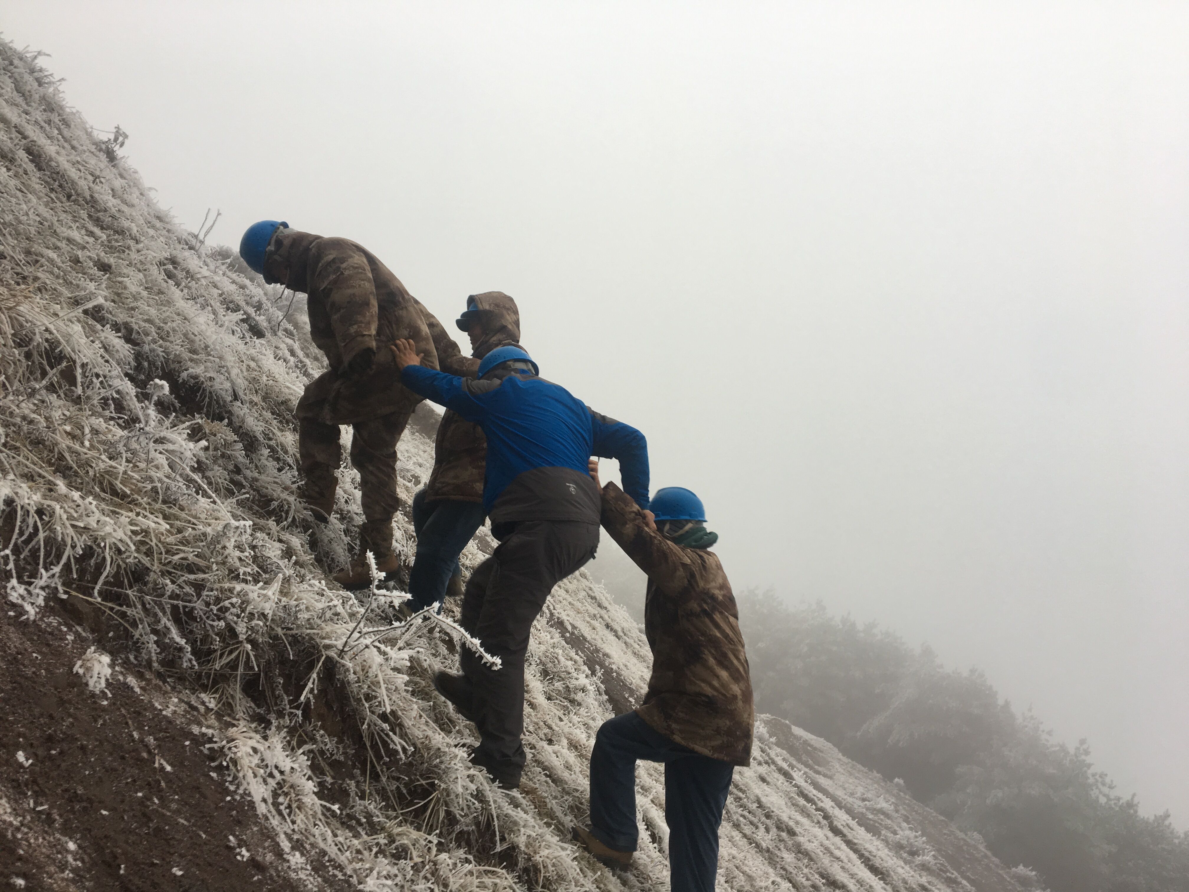 互相攙扶，勇登高峰。（李健攝）